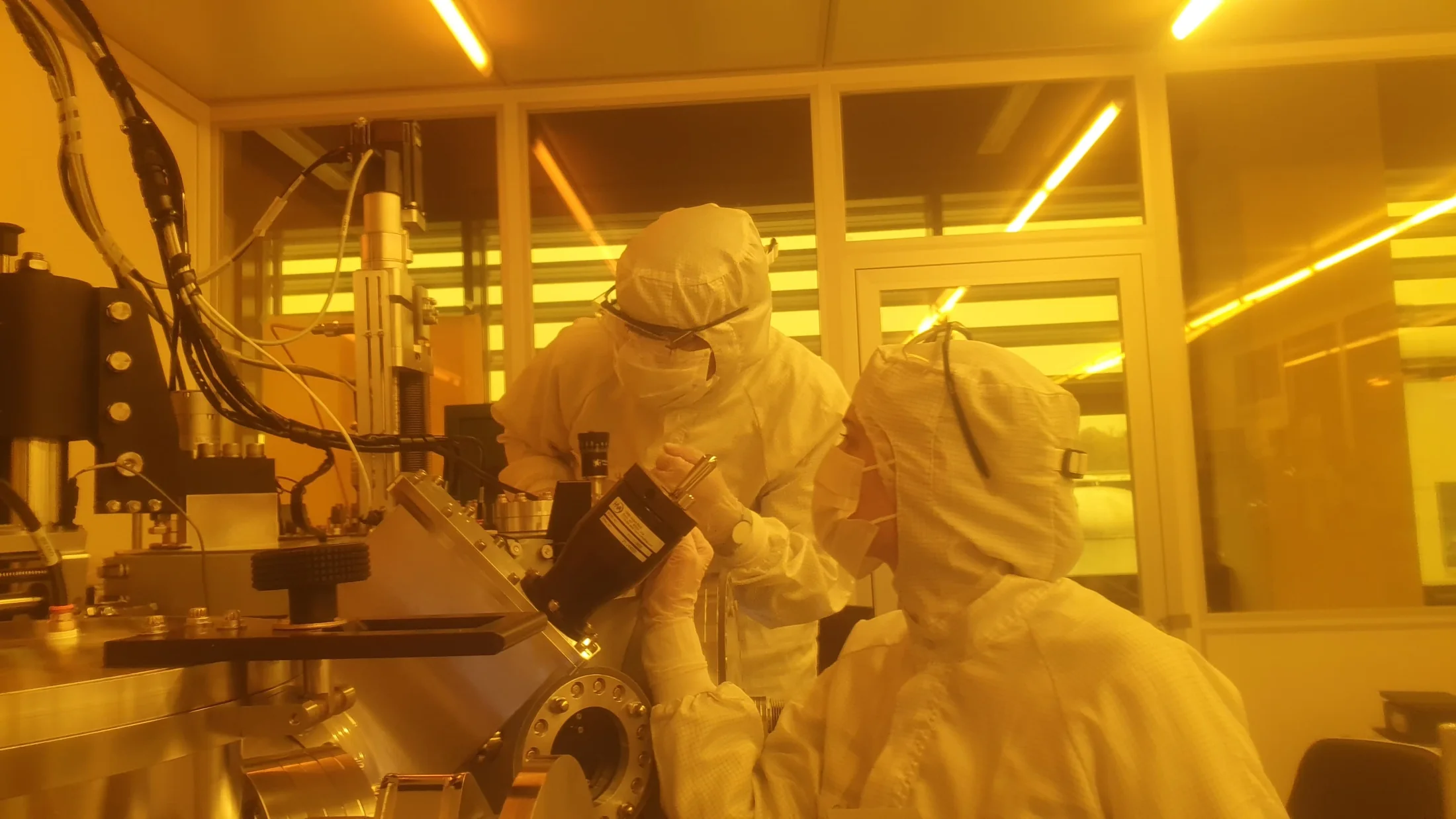Researchers working together inside the cleanroom